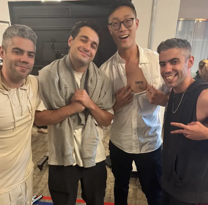 Cast members smile together between takes