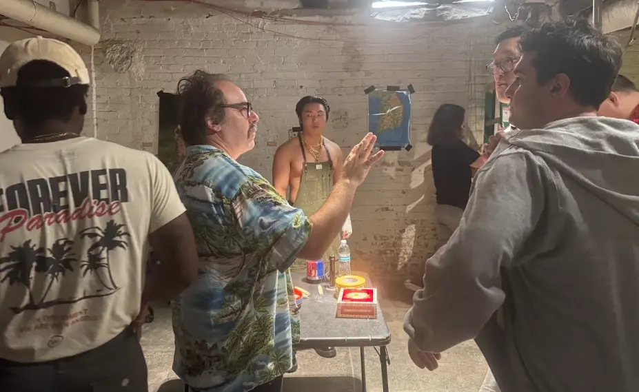 The director gives notes in the basement